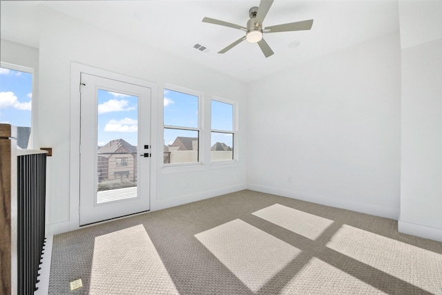 interior space with visible vents, carpet flooring, baseboards, and ceiling fan