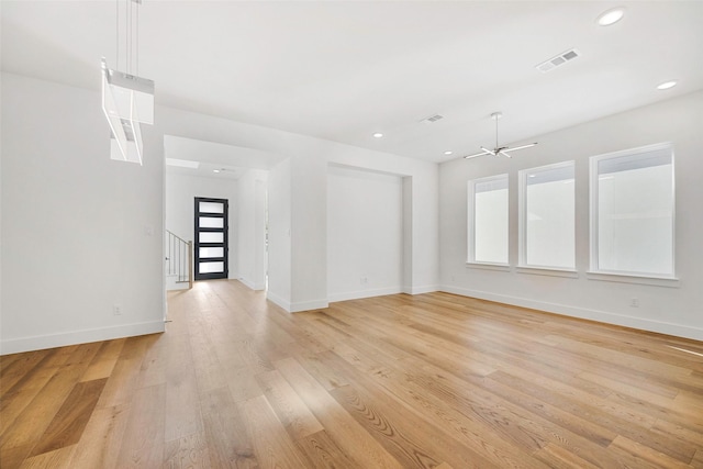 spare room with visible vents, recessed lighting, light wood-type flooring, and baseboards