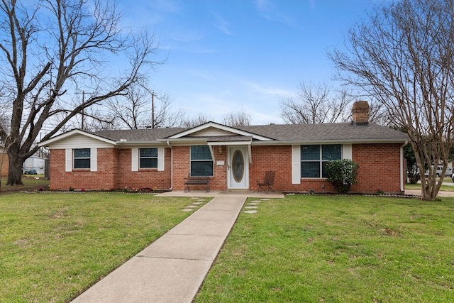 single story home with a front yard, brick siding, roof with shingles, and a chimney