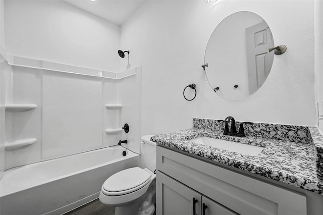 bathroom featuring toilet, shower / washtub combination, wood finished floors, and vanity