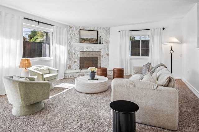 living area with baseboards, carpet floors, and a fireplace