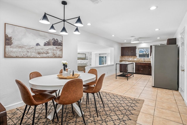 dining area featuring light tile patterned floors, recessed lighting, and baseboards