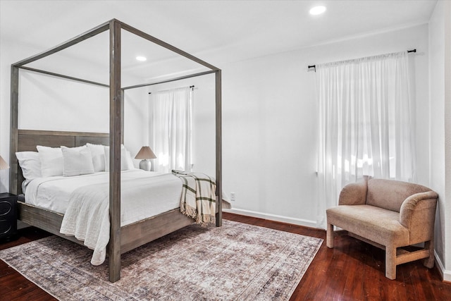 bedroom with recessed lighting, wood finished floors, and baseboards