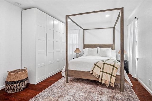 bedroom featuring dark wood finished floors