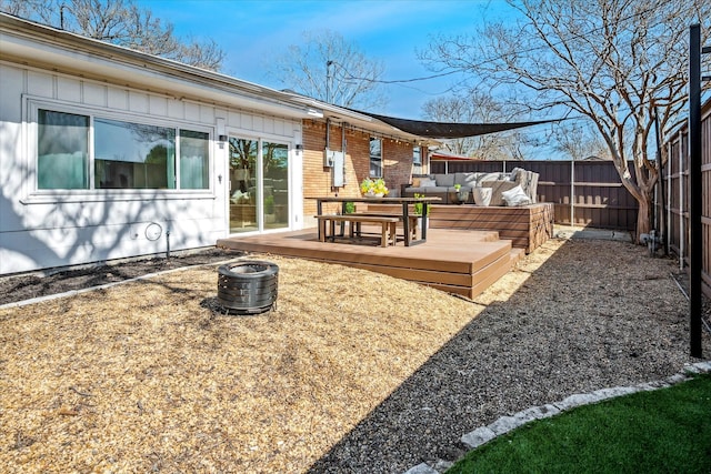 exterior space with a deck, an outdoor living space, and fence