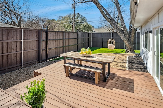 wooden terrace with outdoor dining area and a fenced backyard