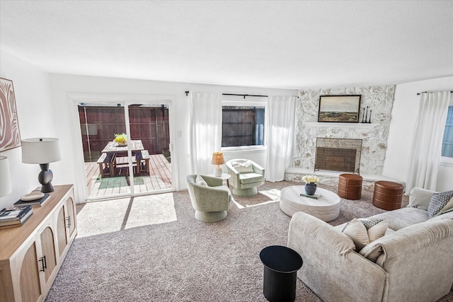 carpeted living area featuring a premium fireplace