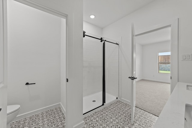 bathroom with tile patterned floors, toilet, baseboards, and tiled shower