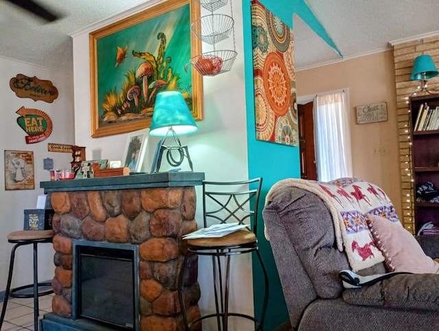 living area featuring ornamental molding, a fireplace, and a textured ceiling