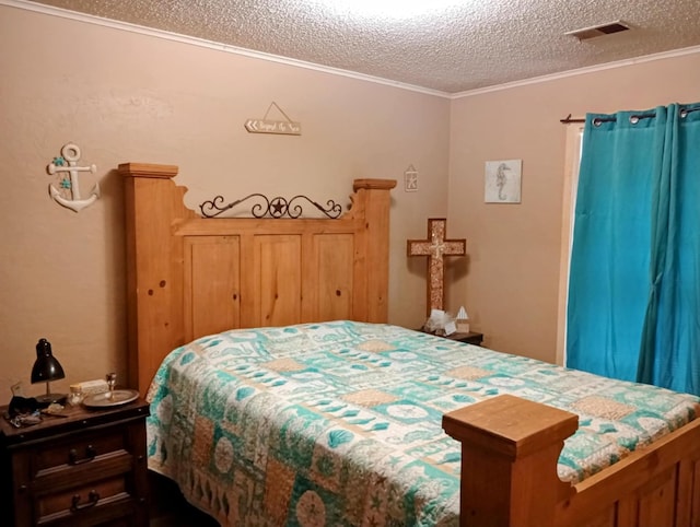 bedroom with visible vents, a textured ceiling, and ornamental molding