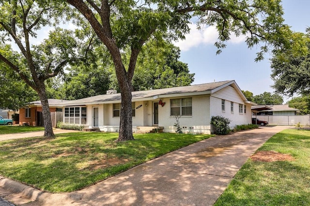 ranch-style home featuring a front yard, fence, brick siding, and a chimney