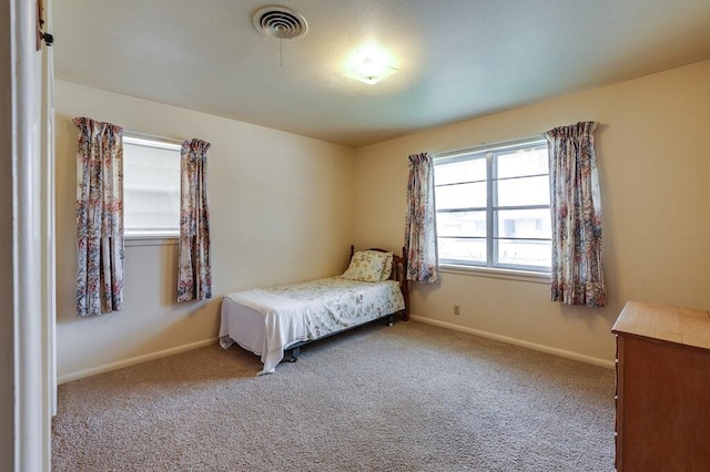 bedroom featuring carpet flooring, visible vents, and baseboards