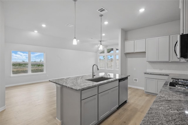 5102 Noland Dr, Princeton, TX 75071 - kitchen featuring stainless steel appliances, a sink, light stone counters, light wood-style floors, and open floor plan