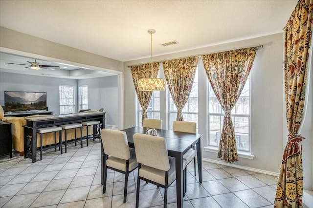 dining space featuring visible vents, baseboards, light tile patterned flooring, and a ceiling fan