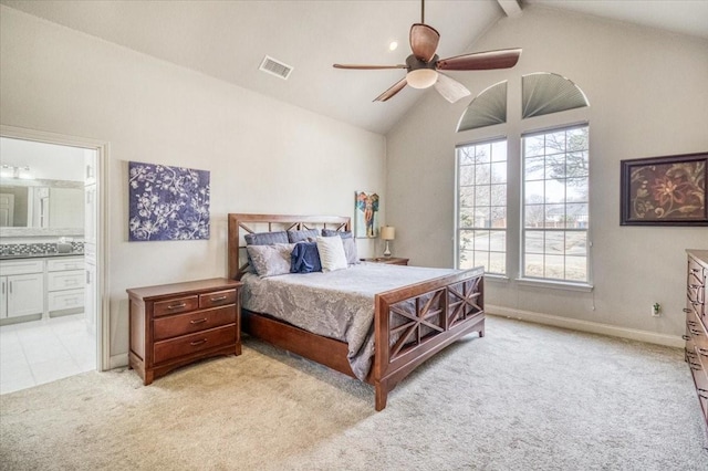 bedroom with visible vents, light carpet, high vaulted ceiling, connected bathroom, and ceiling fan