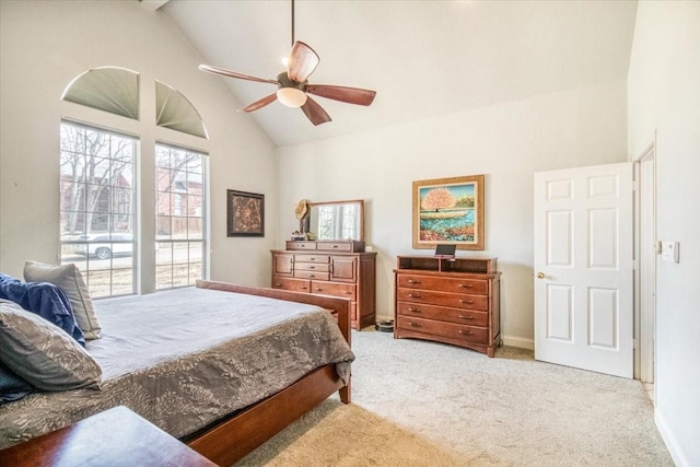 bedroom with a ceiling fan, carpet, baseboards, and high vaulted ceiling