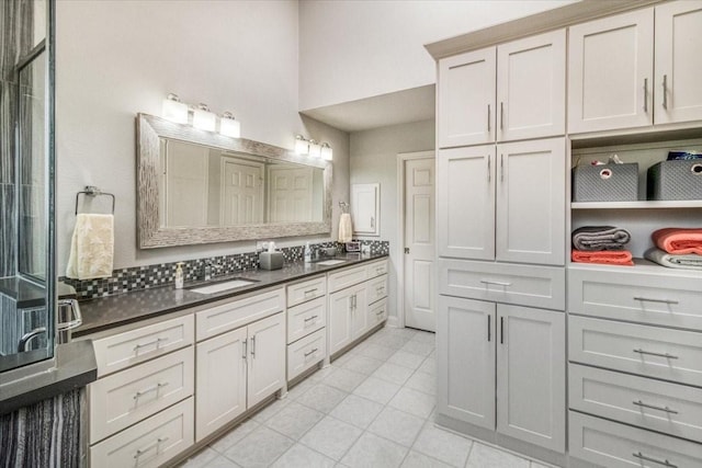 bathroom with double vanity, tile patterned floors, and a sink