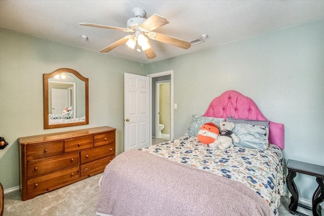 bedroom with visible vents, light colored carpet, and ceiling fan