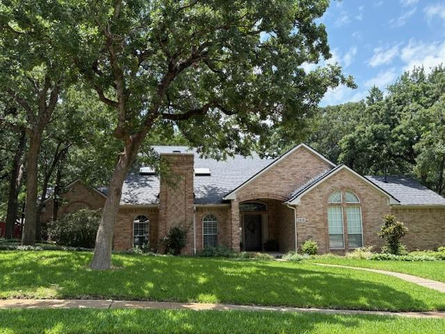 3810 Shady Meadow Dr, Grapevine, TX 76051 - view of front of property with a chimney, a front lawn, and brick siding