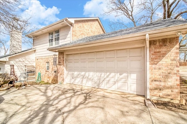 view of front of property featuring driveway, brick siding, an attached garage, and a shingled roof