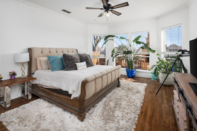 bedroom with visible vents, multiple windows, and ornamental molding