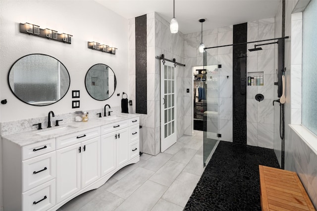 full bathroom featuring double vanity, a walk in shower, and a sink