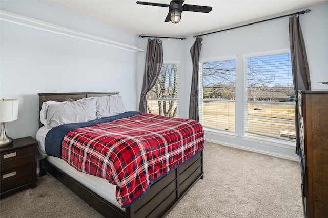 carpeted bedroom with baseboards and ceiling fan