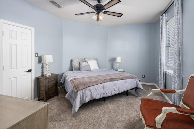 carpeted bedroom with visible vents, baseboards, and ceiling fan