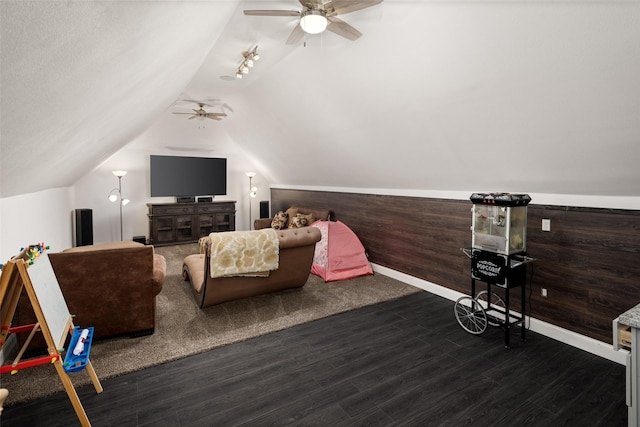 interior space with wooden walls, wood finished floors, and vaulted ceiling