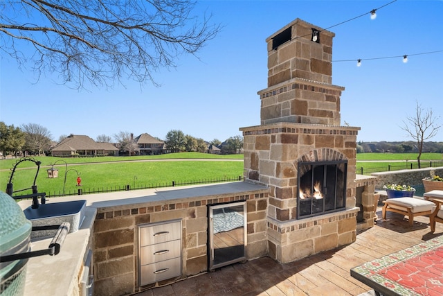 view of patio / terrace featuring an outdoor stone fireplace