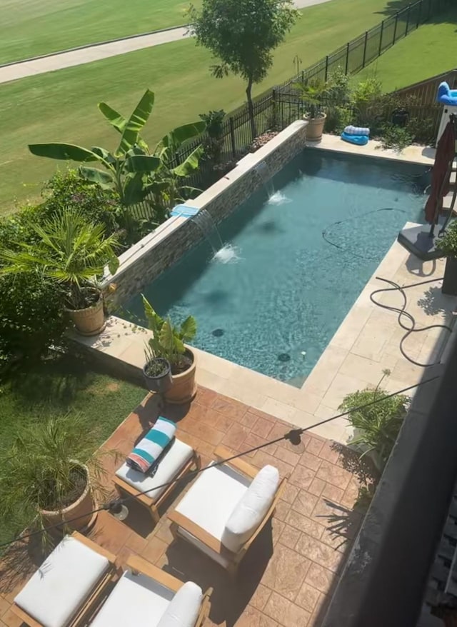 view of swimming pool featuring a patio area, a fenced backyard, and a fenced in pool