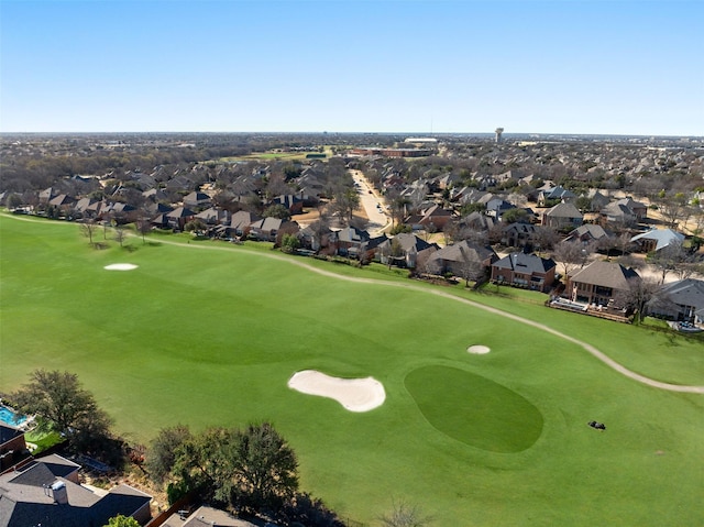 drone / aerial view with view of golf course and a residential view