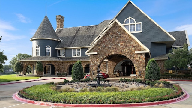 view of front of home featuring driveway and a chimney