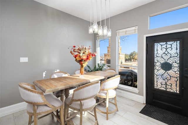 dining space featuring baseboards