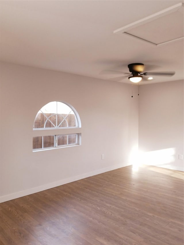 empty room with baseboards and wood finished floors