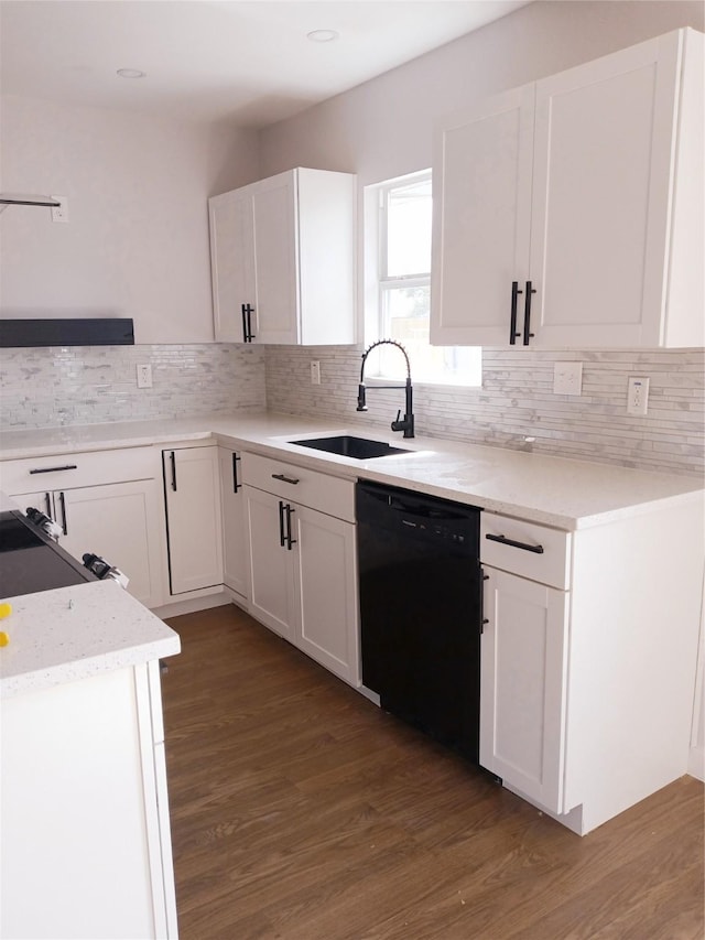 kitchen with white cabinetry, dishwasher, wood finished floors, and a sink