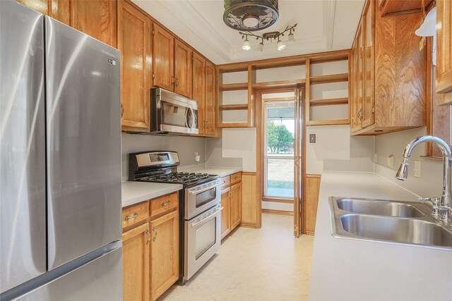 kitchen with visible vents, a tray ceiling, wooden walls, wainscoting, and light countertops