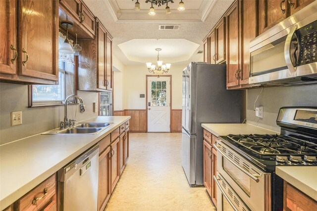 kitchen with a sink, light floors, light countertops, stainless steel appliances, and open shelves