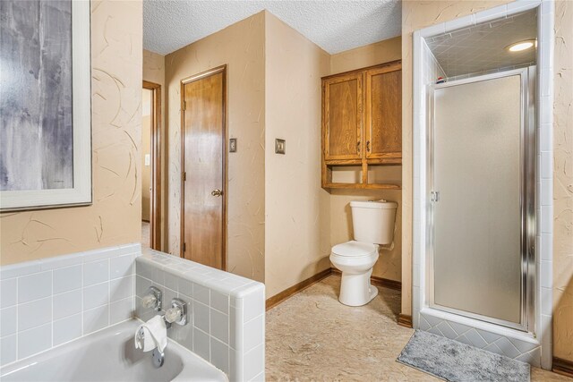 bathroom featuring baseboards, vanity, a garden tub, a textured wall, and a textured ceiling