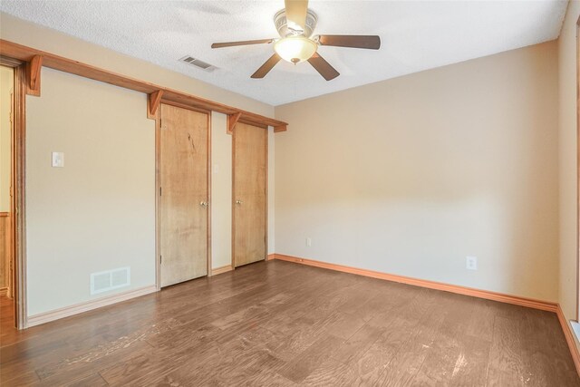 spare room featuring wood finished floors, baseboards, and ceiling fan