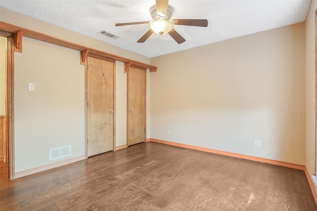 unfurnished bedroom featuring visible vents, baseboards, and wood finished floors