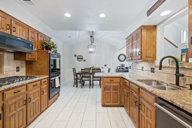 kitchen with visible vents, lofted ceiling, a sink, stainless steel appliances, and extractor fan