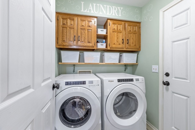 laundry room with cabinet space and washer and clothes dryer