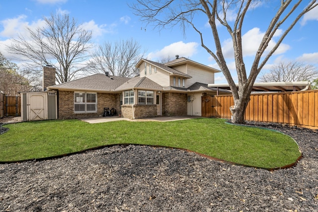 back of property featuring brick siding, a shed, a fenced backyard, an outbuilding, and a patio