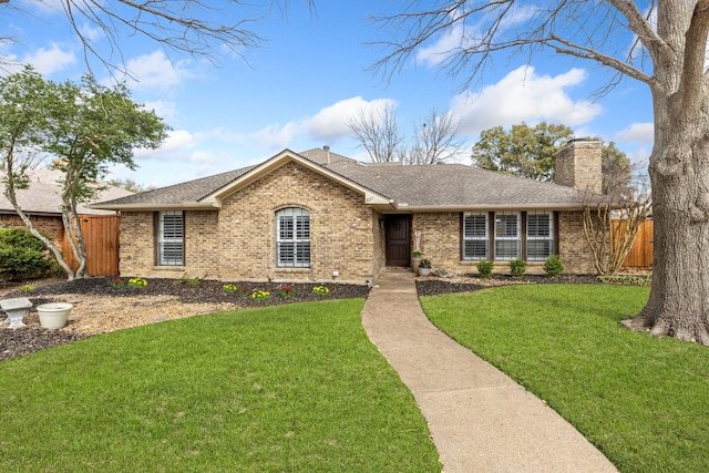 single story home with brick siding, a chimney, and fence