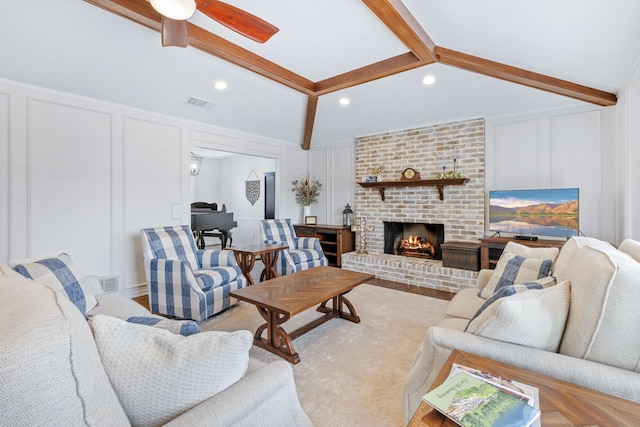 living room with a decorative wall, a fireplace, and visible vents