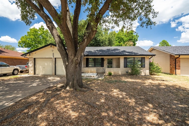 single story home featuring a garage, brick siding, roof with shingles, and concrete driveway