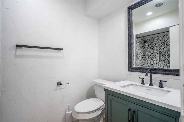 bathroom with a shower with shower curtain, toilet, vanity, and a textured wall