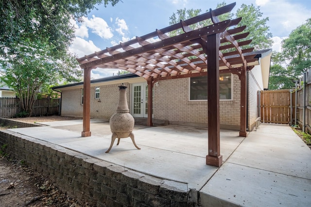 view of patio with fence, a pergola, and french doors