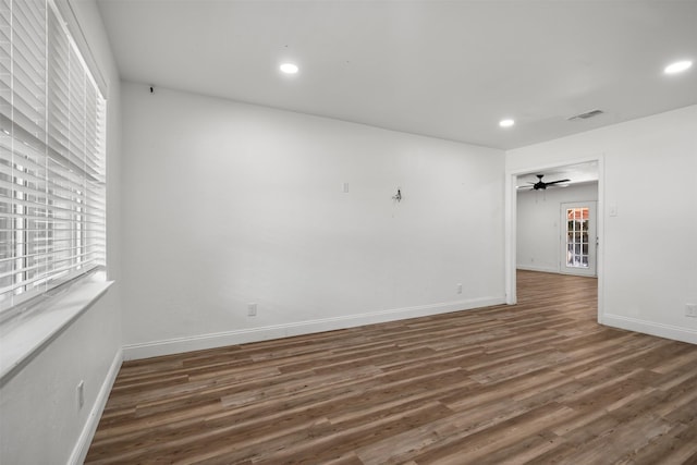 spare room with recessed lighting, wood finished floors, and a wealth of natural light